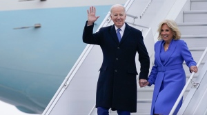President Joe Biden waves as he and first lady Jill Biden exit Air Force One as they arrive at Ottawa International Airport, Thursday, March 23, 2023, in Ottawa, Canada. (AP Photo/Andrew Harnik)