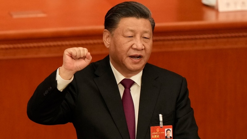 Chinese President Xi Jinping takes his oath after he is unanimously elected as President during a session of China's National People's Congress (NPC) at the Great Hall of the People in Beijing, on March 10, 2023. (Mark Schiefelbein / AP) 