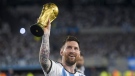 Argentina's Lionel Messi hoists the FIFA World Cup trophy during a celebration ceremony for local fans after an international friendly soccer match against Panama at the Monumental stadium in Buenos Aires, Argentina, Thursday, March 23, 2023. (AP Photo/Gustavo Garello)