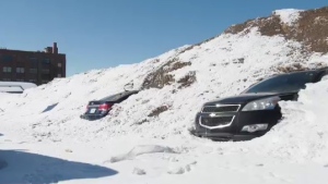 Two cars have begun to emerge from a large snow pile in Regina. (KatySyrota/CTVNews) 