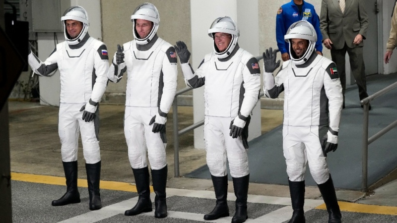 From left, Russian cosmonaut Andrei Fedyaev, NASA astronauts Warren Hoburg and Stephen Bowen, and United Arab Emirates astronaut Sultan al-Neyadi wave as they leave the Operations and Checkout building for a trip to Launch Pad 39-A Wednesday, March 1, 2023, at the Kennedy Space Center in Cape Canaveral, Fla. (AP Photo/John Raoux)