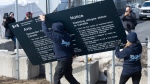 Workers remove current warning signs at the irregular border at Roxham Road from New York into Canada on Friday, March 24, 2023 in Champlain, N.Y. THE CANADIAN PRESS/Ryan Remiorz
