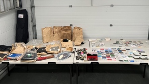 On Wednesday, the Greater Victoria Emergency Response Team assisted detectives in raiding the property, where they uncovered a cache of ID cards, passports, laptops and other personal items, Saanich police said. (Saanich police)