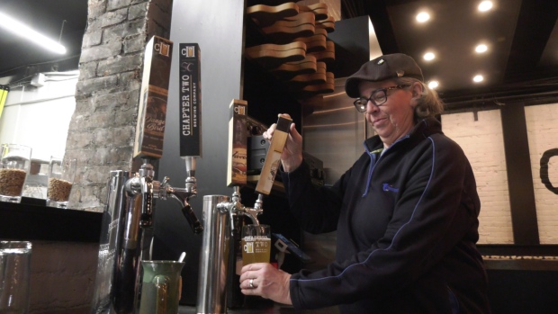 Cheryl Watson, general manager and co-owner of Chapter Two Brewing Company, pours a pint of beer in Windsor, Ont. on March 24, 2023. (Rich Garton/CTV News Windsor)