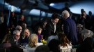 Canadian Prime Minister Justin Trudeau takes his seat as President Joe Biden gets up to speak during a gala dinner at the Canadian Aviation and Space Museum, Friday, March 24, 2023, in Ottawa, Canada. (AP Photo/Andrew Harnik)
