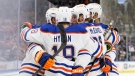 Edmonton Oilers left wing Zach Hyman (18) and centre Connor McDavid (97) celebrate a goal against the Toronto Maple Leafs with teammates during first period NHL hockey action in Toronto on Saturday, Mar. 11, 2023. (THE CANADIAN PRESS/Cole Burston)