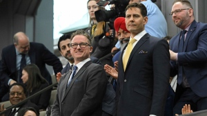 Canadians Michael Kovrig and Michael Spavor stand as they are recognized before President Joe Biden speaks to the Canadian Parliament in Ottawa, Canada, Friday, Mach 24, 2023. (Mandel Ngan/Pool via AP)