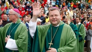 In this May 25, 2008, file photo, Bishop Franz-Josef Bode waves during the closing service of the 97th German Catholics Day in Osnabrueck, northern Germany. (AP Photo/Joerg Sarbach, File)