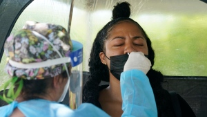 A woman gets a COVID-19 PCR test at a testing site on July 26, 2021, in Miami. (AP Photo/Marta Lavandier) 