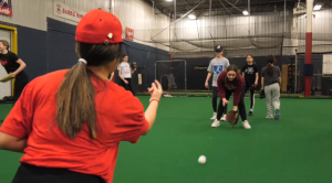 A coach throws to one of the participants at a baseball clinic held in Barrie on Sat., March 25 (Christopher Garry/CTV News). 