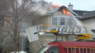 Calgary firefighters douse flames at a home on Citadel Way on March 24, 2023. 
