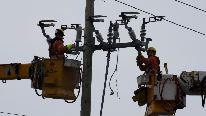 Hydro Quebec employees work on a power line Tuesday, March 21, 2023 in Deux-Montagnes, Que.THE CANADIAN PRESS/Ryan Remiorz