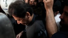Former Prime Minister Imran Khan leaves after appearing in a court, in Lahore, Pakistan, Friday, March 24, 2023. A Pakistani court on Friday shielded from arrest former Prime Minister Khan until at least next week, amid a roiling political crisis that has pitted the celebrity politician against the current government and spilled over into street protests (AP Photo/K.M. Chaudary)