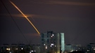 Russian rockets launched against Ukraine from Russia's Belgorod region streak across the sky at dawn in Kharkiv, Ukraine on March 24, 2023. (AP Photo/Vadim Belikov)