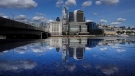 The skyline of London is reflected in the polished stones of London Bridge during sunny weather in London, Tuesday, Sept. 21, 2021. (AP Photo/Frank Augstein)