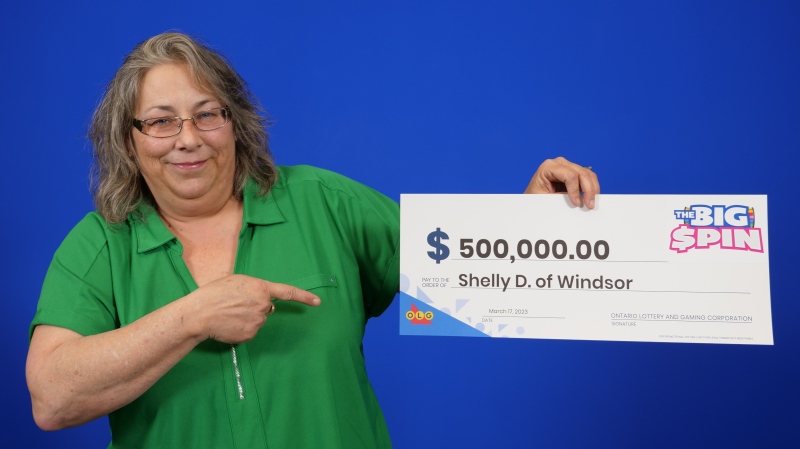 Shelly Desbien of Windsor, Ont. with her $500,000 winnings at the OLG Prize Centre in Toronto, Ont. (Source: OLG)