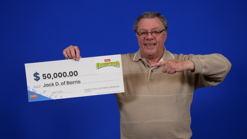 Jack Desrocher, of Barrie, Ont., holds his big cheque at the OLG Prize Centre in Toronto (OLG)