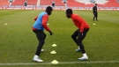 Jonathan David (left) and Alphonso Davies take part in a drill Monday, March 27, 2023 at Canada’s training session at BMO Field in Toronto. The Canadian men play Honduras in CONCACAF Nations League play Tuesday. THE CANADIAN PRESS/Neil Davidson