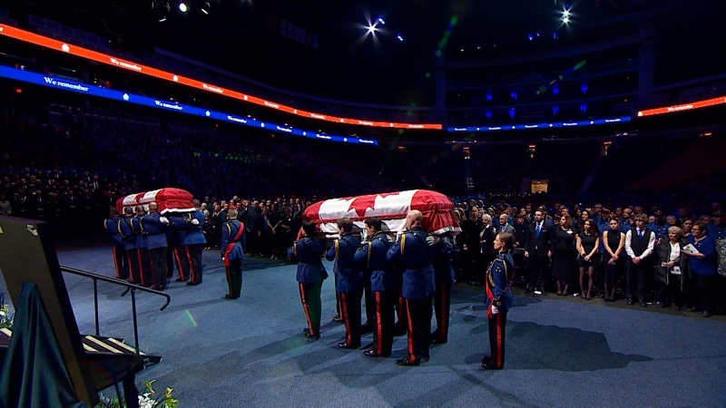 The bodies of Constables Travis Jordan and Brett Ryan are brought into the regimental funeral at Rogers Place.