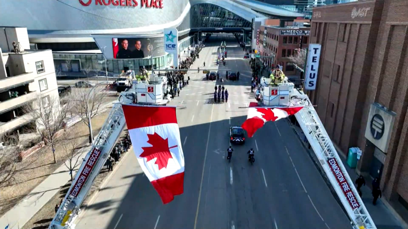 Thousands of law enforcement and emergency officials, as well as members of the public, lined the procession route for Constables Brett Ryan and Travis Jordan to be taken to Rogers Place in Edmonton on March 27, 2023. 