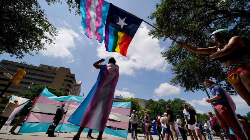 In this file photo, demonstrators gather on the steps to the State Capitol to speak against transgender-related legislation bills being considered in the Texas Senate and Texas House, May 20, 2021 in Austin, Texas. New legislation introduced in 2023 in states including Texas are now including adults in health-care bans, either through direct bans or by limiting access to medical coverage. (AP Photo/Eric Gay, File)