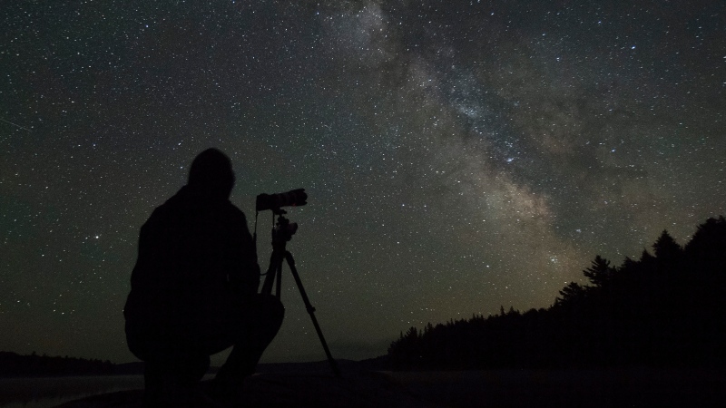 Stargazer Junbo Liang from Toronto photographs the Milky Way lighting up clear night sky over Algonquin Park Saturday June 12, 2021. With provincial re-opening people from across Ontario flocked to Ontario's marquee provincial park. THE CANADIAN PRESS/Fred Thornhill