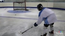 Young hockey star practices in backyard rink