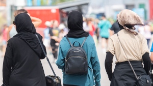 Women wear hijabs as they walk in the Old Port in Montreal, Thursday, August 11, 2022. THE CANADIAN PRESS/Graham Hughes