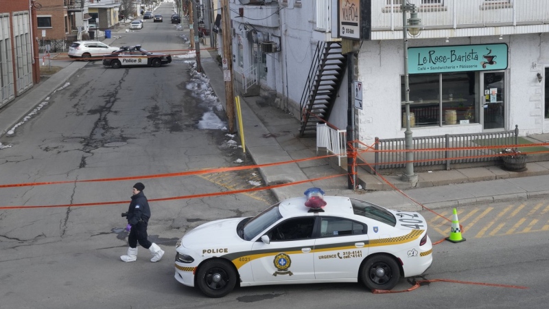 Police tape cordons off the scene after a Quebec provincial police officer was killed while trying to arrest a man in Louiseville, Que., Tuesday, March 28, 2023. (THE CANADIAN PRESS/Ryan Remiorz)