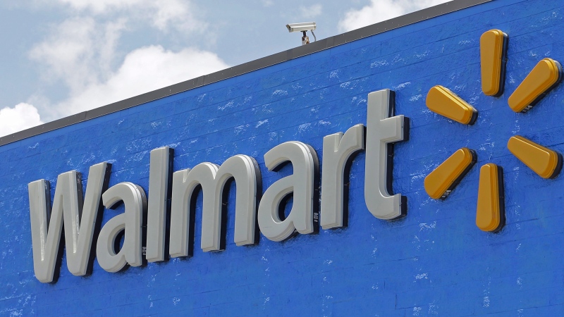 This June 1, 2017, file photo, shows a Walmart sign at a store in Hialeah Gardens, Fla. Walmart is rolling out next-day delivery on its most popular items, raising the stakes in the retail shipping wars. The nation's largest retailer says Tuesday, May 13, 2019, it's been building its own network of more efficient e-commerce distribution centers to enable the faster delivery. (AP Photo/Alan Diaz, File)