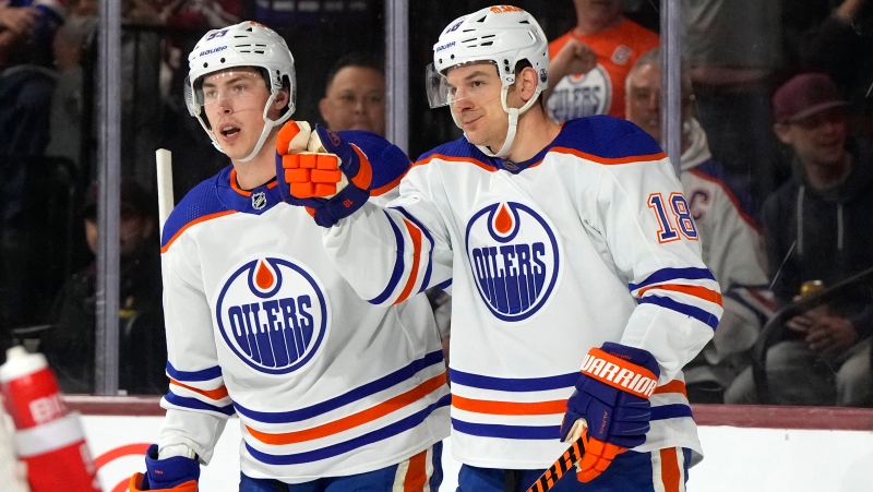 Edmonton Oilers Zach Hyman (18) celebrates with Ryan Nugent-Hopkins after scoring a goal against the Arizona Coyotes in the first period during an NHL hockey game, Monday, March 27, 2023, in Tempe, Ariz. (AP Photo/Rick Scuteri)