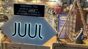 A Juul sign hangs in the front window of a bodega convenience store in New York City on June 25, 2022. Vaping company Juul Labs will pay Chicago $23.8 million to settle a lawsuit alleging the company marketed harmful vaping products to underage users, the city announced Friday, March 10, 2023. (AP Photo/Ted Shaffrey, File)