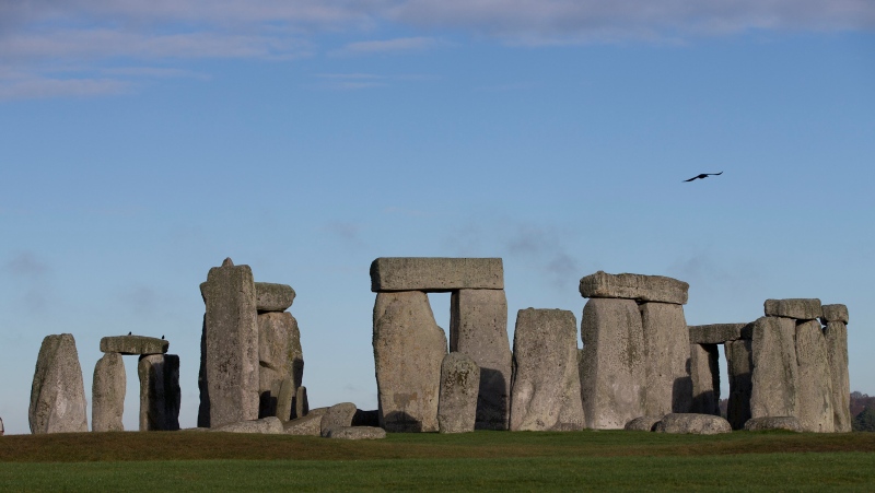 In this Tuesday, Dec. 17, 2013 file photo, visitors take photographs of the world heritage site of Stonehenge, in Wiltshire, England. (AP Photo/Alastair Grant, File)
