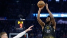 Golden State Warriors forward Andrew Wiggins (22) shoots against Washington Wizards center Kristaps Porzingis, left, during the first half of an NBA basketball game in San Francisco, Monday, Feb. 13, 2023. (AP Photo/Jed Jacobsohn)