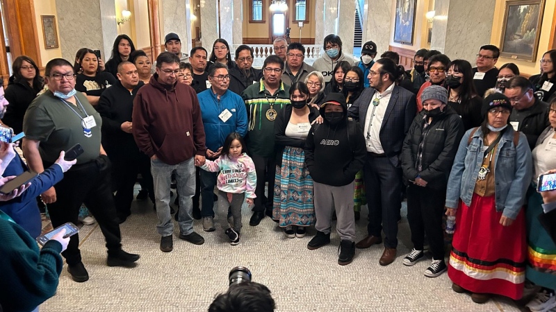 Neskantaga Chief Wayne Moonias, centre in green, speaks alongside First Nations community members during an improvised press conference inside the Ontario Legislature, at Queen's Park, in Toronto, Wednesday, March 29, 2023. (THE CANADIAN PRESS/Allison Jones)