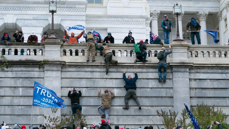 In this file photo, violent insurrectionists loyal to former U.S. President Donald Trump scale the west wall of the the U.S. Capitol in Washington, Jan. 6, 2021. (AP Photo/Jose Luis Magana, File)