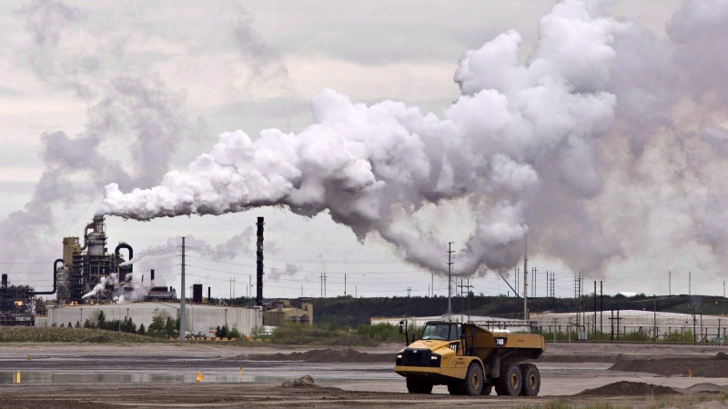 A dump truck works near the Syncrude oil sands extraction facility near the city of Fort McMurray, Alberta on Sunday June 1, 2014. THE CANADIAN PRESS/Jason Franson