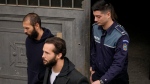 Police officers escort Andrew Tate handcuffed to his brother Tristan, right, from the Court of Appeal after they appealed the decision to extend their arrest by another 30 days term in Bucharest, Romania, Monday, Feb. 27, 2023. (AP Photo/Andreea Alexandru)