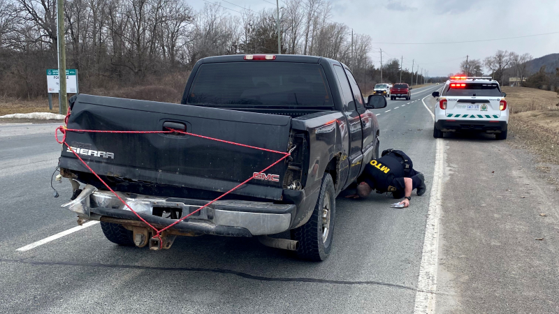 Ontario Provincial Police say officers stopped a vehicle on Trenton-Frankford Road in Quinte Region on Saturday with the back held together by a bungee cord. (Ontario Provincial Police/Twitter) 