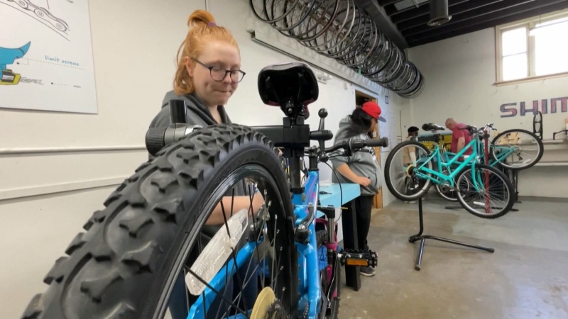 Young adults gaining life skills fixing bicycles