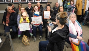 Those who supported a motion opposing Bill 42 hold up signs at a Plympton-Wyoming town council meeting on March 30, 2023. (Gerry Dewan/CTV News London)