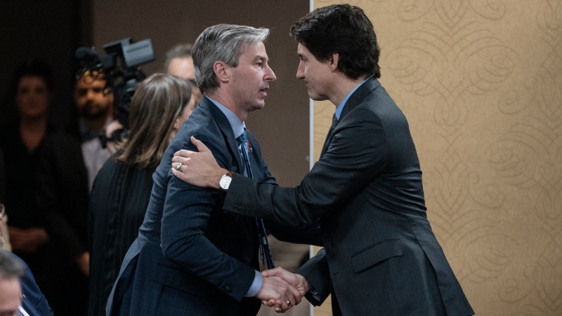 Prime Minister Justin Trudeau, right, is greeted by Nova Scotia Premier Tim Houston prior to the final report of the Mass Casualty Commission inquiry into the mass murders in rural Nova Scotia in Truro, N.S. on Thursday, March 30, 2023. THE CANADIAN PRESS/Darren Calabrese