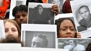 Students from Philadelphia hold photos of gun violence victims at a rally at the Pennsylvania Capitol pressing for stronger gun-control laws, Thursday, March 23, 2023, in Harrisburg, Pa. (AP Photo/Marc Levy)