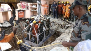 Rescuers work at the site of a structure built over an old temple well that collapsed Thursday as a large crowd of devotees gathered for the Ram Navami Hindu festival, in Indore, India, Friday, March 31, 2023. (AP Photo)