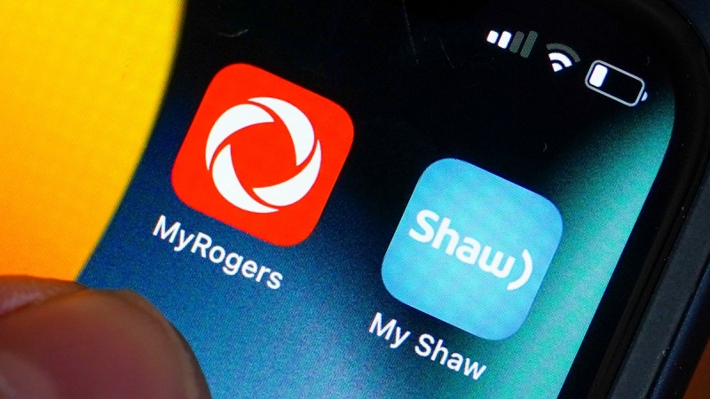 Rogers and Shaw applications are pictured on a cellphone in Ottawa on May 9, 2022. (Sean Kilpatrick / THE CANADIAN PRESS)