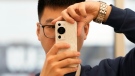 Using the Huawei P60 Pro smartphone launched in Beijing, on March 23, 2023. (Ng Han Guan / AP)