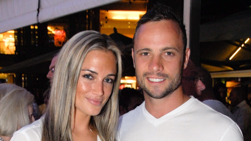 A picture taken on January 26, 2013 shows Olympian sprinter Oscar Pistorius posing next to his girlfriend Reeva Steenkamp at Melrose Arch in Johannesburg. (WALDO SWIEGERS/AFP via Getty Images)
