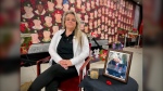 Terri Sopha sits in front of her father's painting, Portraits of Honour, which she's being forced to pack up and move. (CTV Kitchener/Spencer Turcotte)