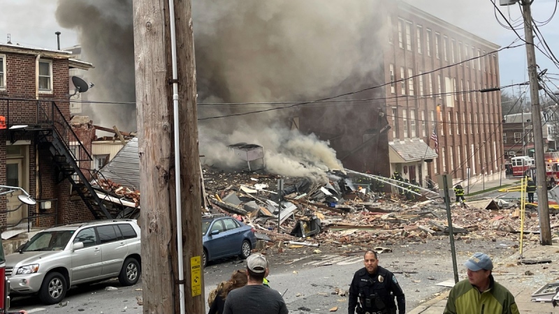 Emergency personnel work at the site of a deadly explosion at a chocolate factory in West Reading, Pa., March 24, 2023. (Ben Hasty /Reading Eagle via AP)