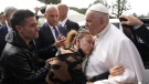 Pope Francis consoles Serena Subania and Matteo Rugghia, left, who lost their 5-year-old daughter Angelica yesterday, as he leaves the Agostino Gemelli University Hospital in Rome, Saturday, April 1, 2023, after receiving treatment for bronchitis. (AP Photo/Gregorio Borgia)
